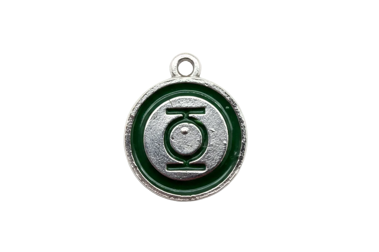 Round silver disc with deep green enamel ring and raised graphic emblem