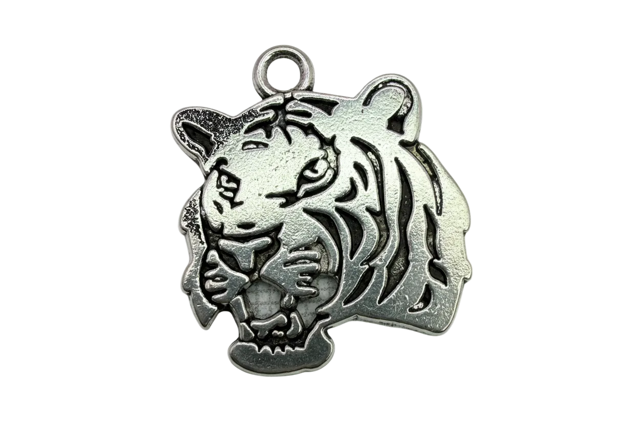 Antique silver tiger head charm with recessed line detailing and a small clear gem accent