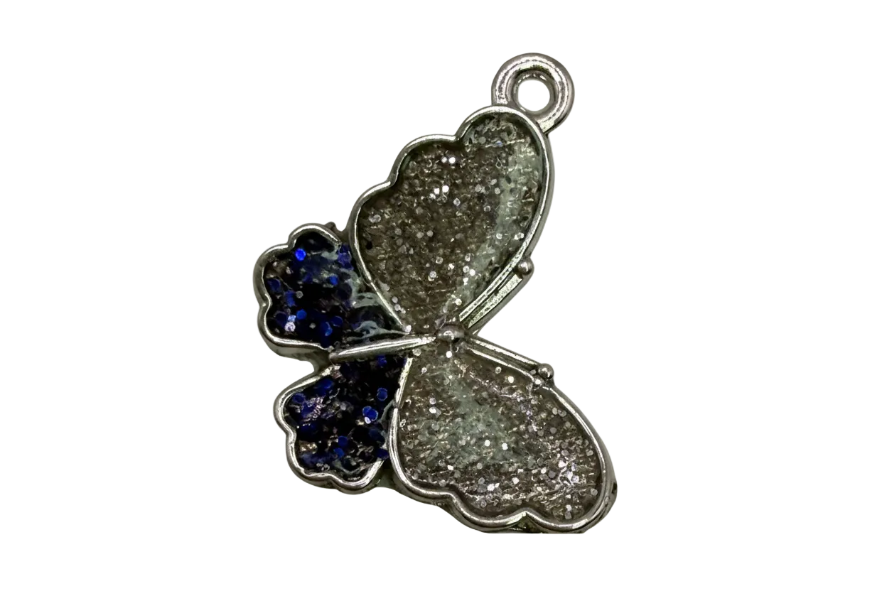 Silver glitter butterfly pendant with navy glitter accent wing and polished silver edging on black background