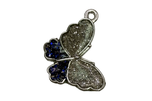 Silver glitter butterfly pendant with navy glitter accent wing and polished silver edging on black background