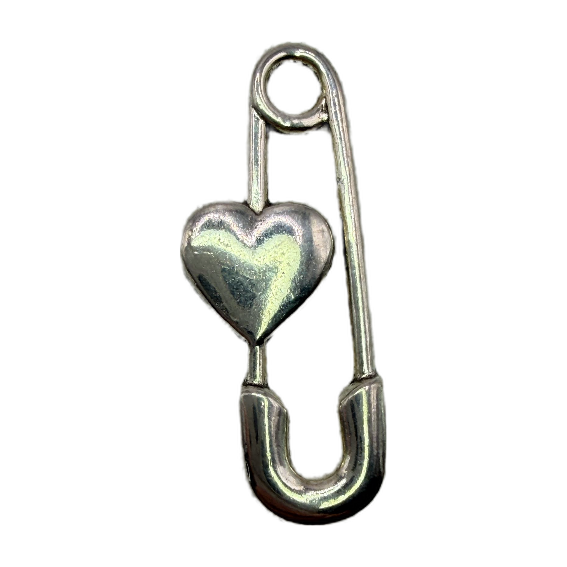 Polished silver safety pin with a puffed heart centerpiece on black background