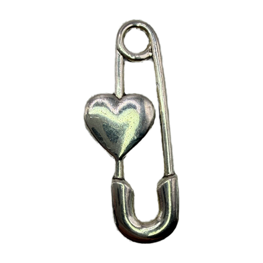 Polished silver safety pin with a puffed heart centerpiece on black background