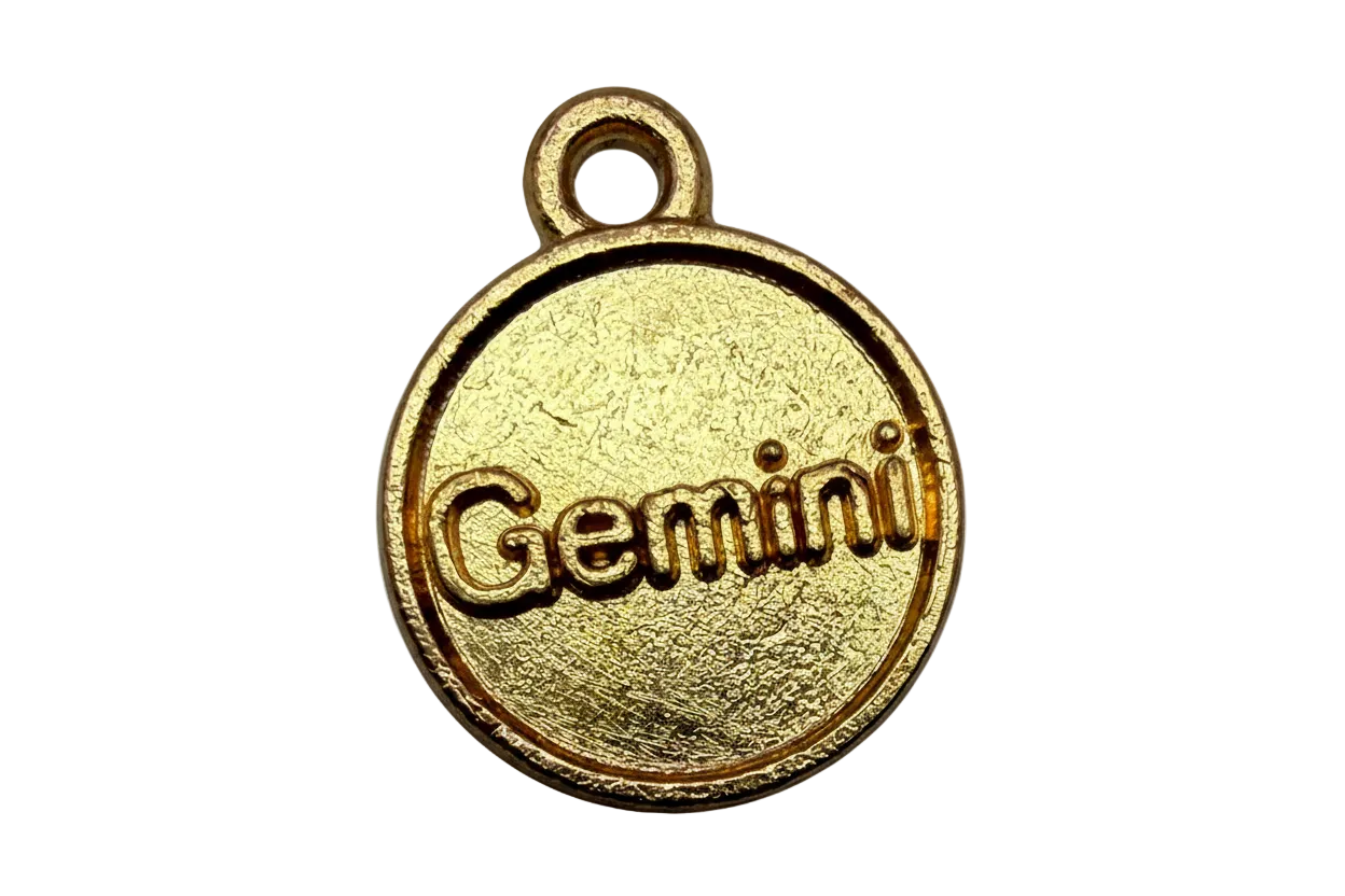 Round gold disc with raised Gemini lettering and textured finish