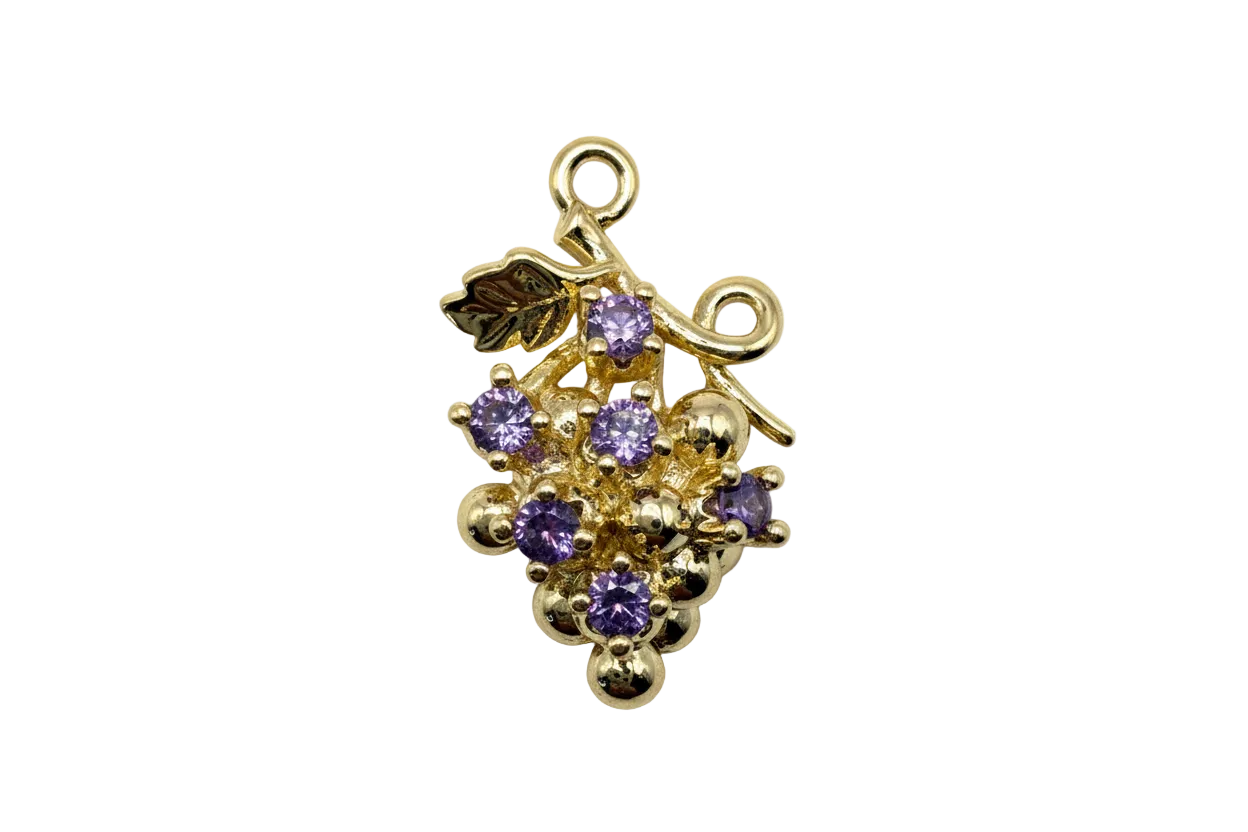 Polished gold grape cluster with faceted violet gems and small leaf detail