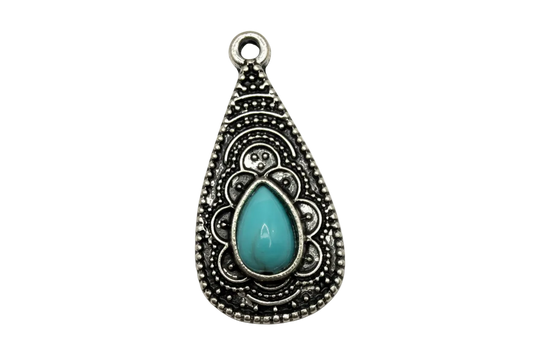 Ornate silver-toned teardrop charm with filigree detail and glossy turquoise teardrop gem