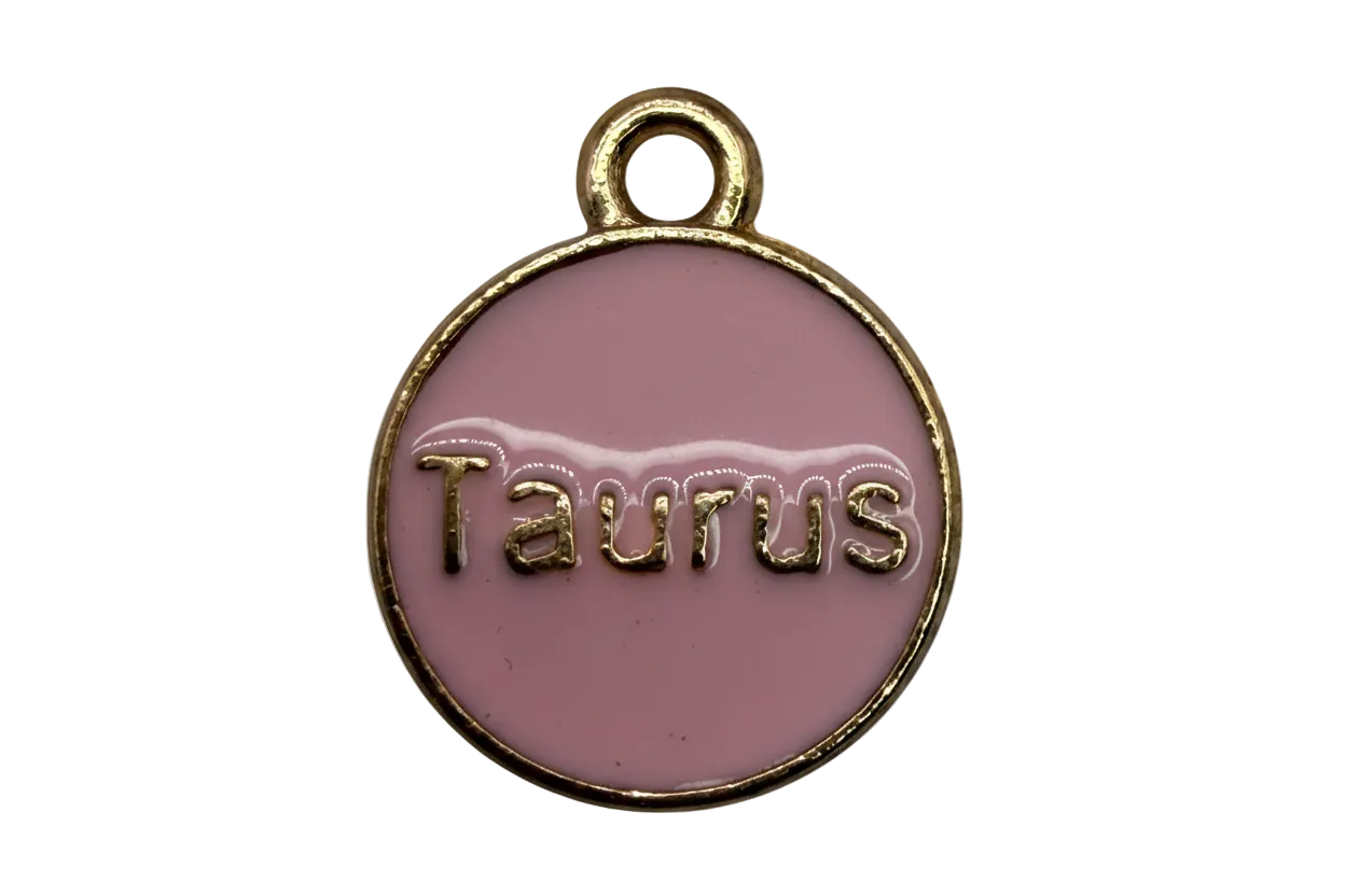 Round blush pink enamel Taurus zodiac coin with raised gold lettering