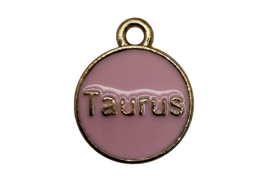 Round blush pink enamel Taurus zodiac coin with raised gold lettering