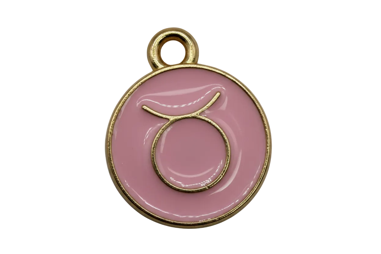 Pink round Taurus zodiac disc with raised gold symbol and glossy finish