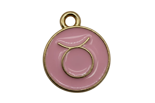Pink round Taurus zodiac disc with raised gold symbol and glossy finish