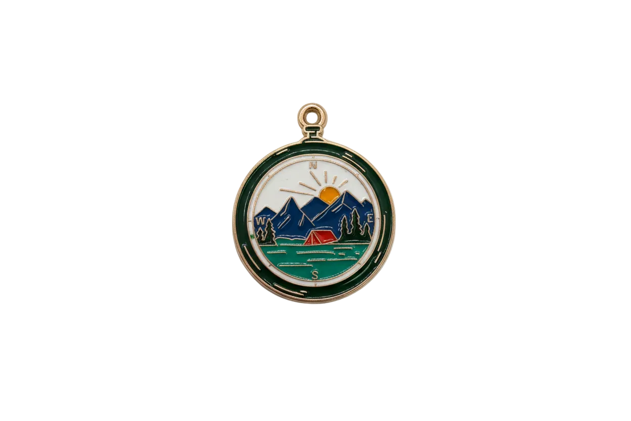 Gold enamel compass medallion with mountain sunrise scene