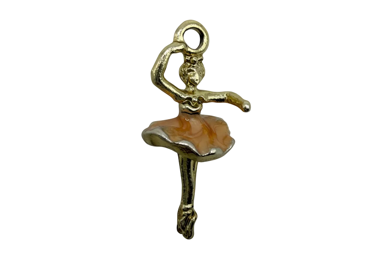 Gold ballerina figure with peach enamel tutu in a ballet pose