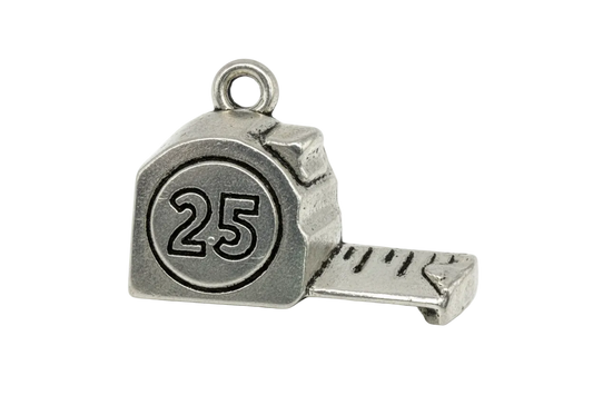 Antique silver tape measure charm with engraved 25 and extended measuring strip