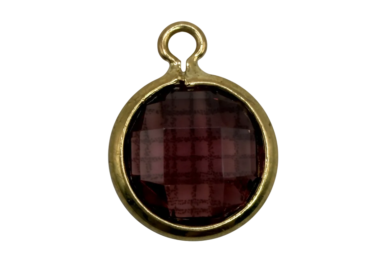 Faceted burgundy round gem in a polished gold frame
