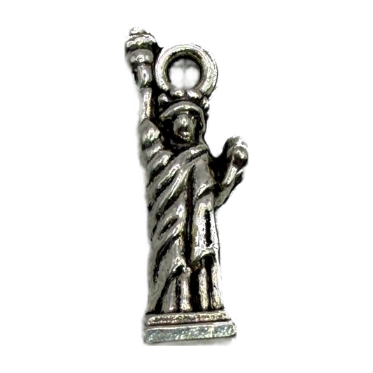 Antique silver Statue of Liberty figure with raised torch and detailed robe