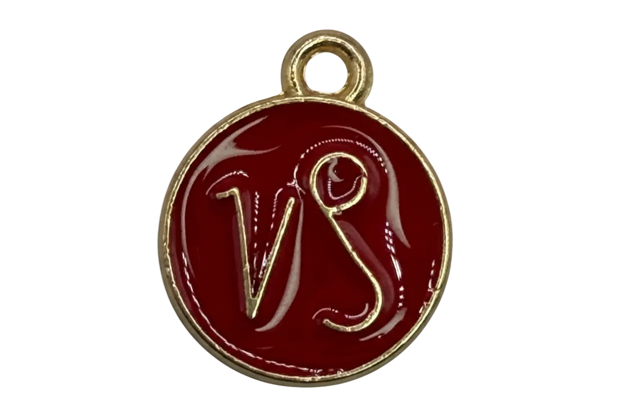 Round burgundy enamel medallion with raised gold VS monogram