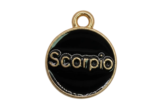 Black enamel round Scorpio zodiac medallion with raised gold lettering and gold border