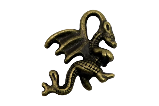 Antiqued gold winged dragon charm with curled tail and sculpted scales