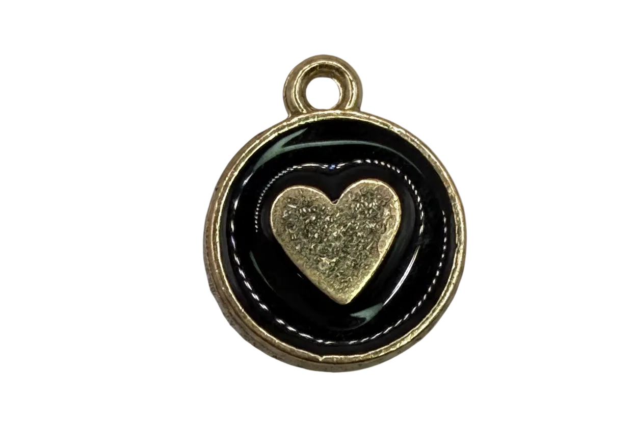 Round gold medallion with glossy black enamel and a raised textured gold heart