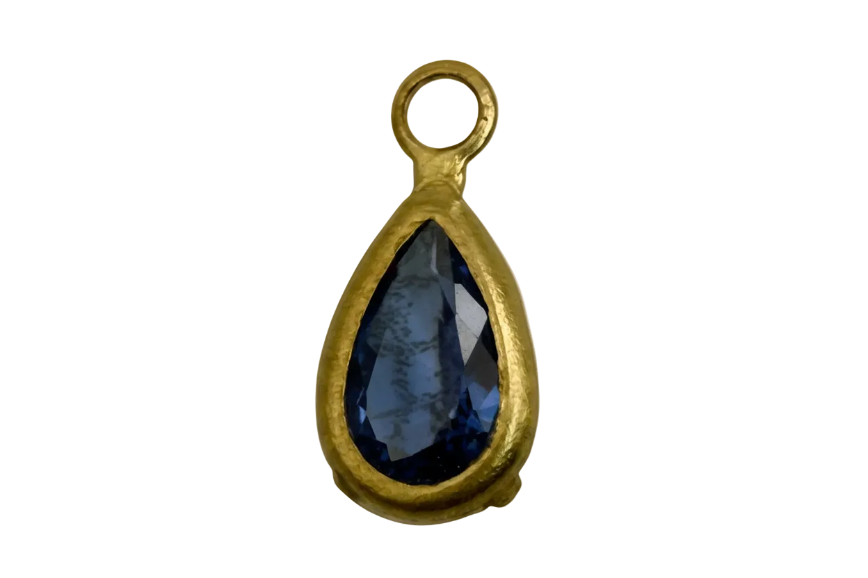Gold teardrop charm with faceted midnight-blue gem