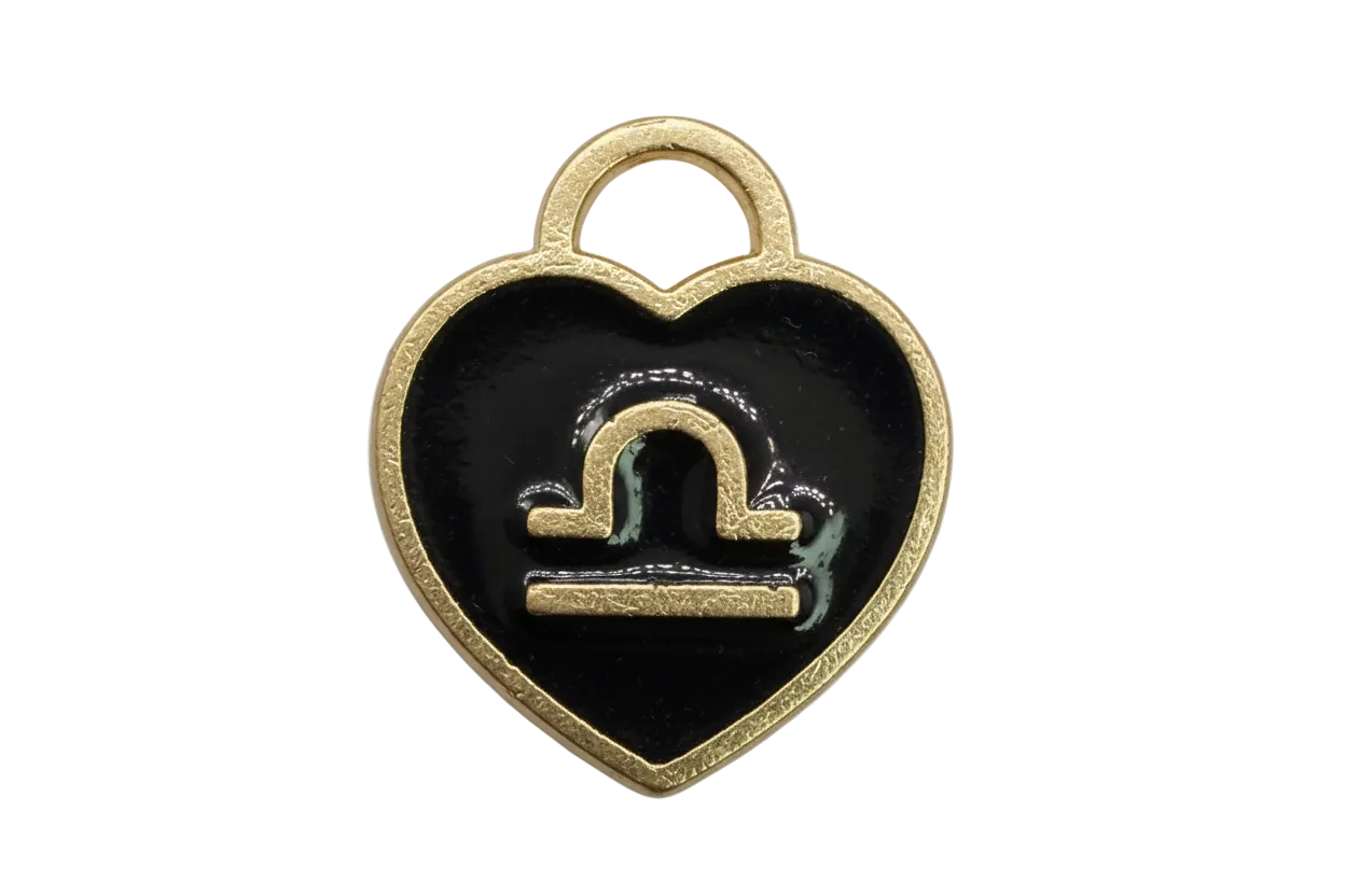 Glossy black Capricorn zodiac medallion with raised gold symbol and white stone accent
