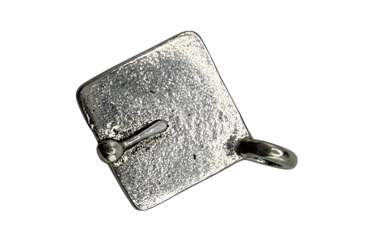 Textured silver-tone suitcase charm with a vintage finish on black background