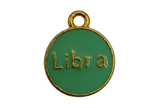 Round green enamel disc with raised gold Libra lettering and gold border