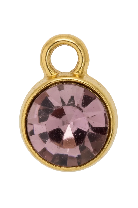 Faceted mauve round gem in a smooth gold frame