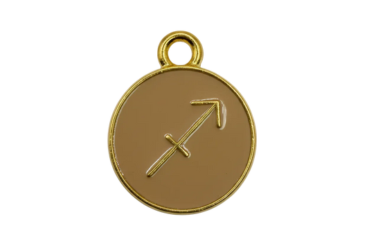 Tan round zodiac disc with Sagittarius arrow symbol and polished gold rim