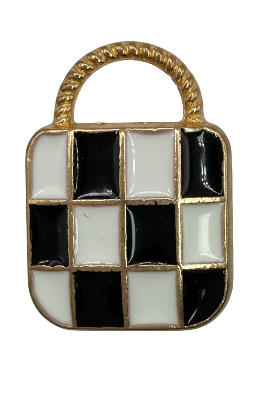 Gold slipper charm with black and white checkered enamel and a patterned white toe