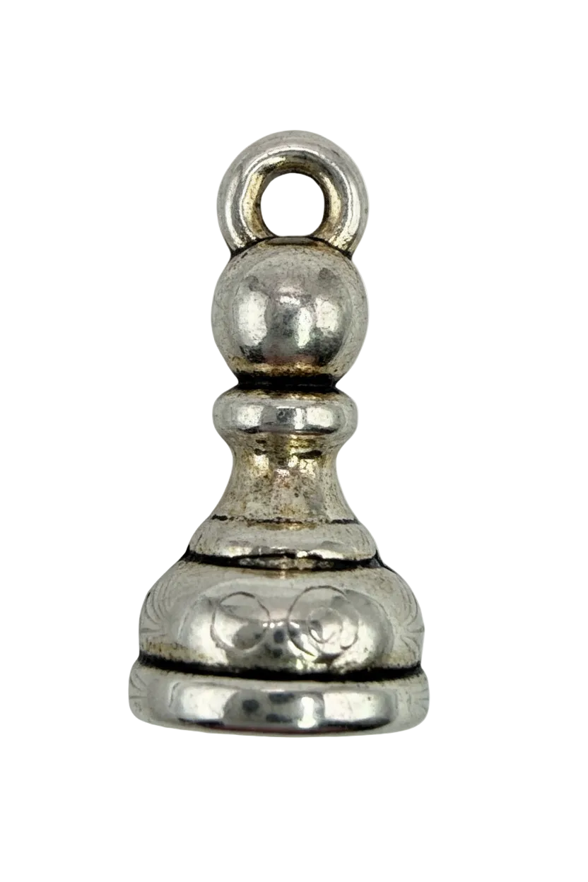 Ornate silver chess pawn with engraved scrollwork and polished finish