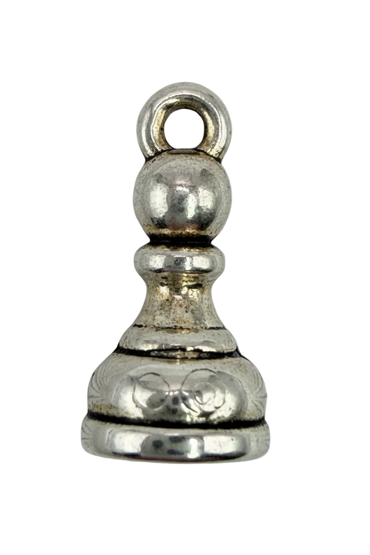 Ornate silver chess pawn with engraved scrollwork and polished finish