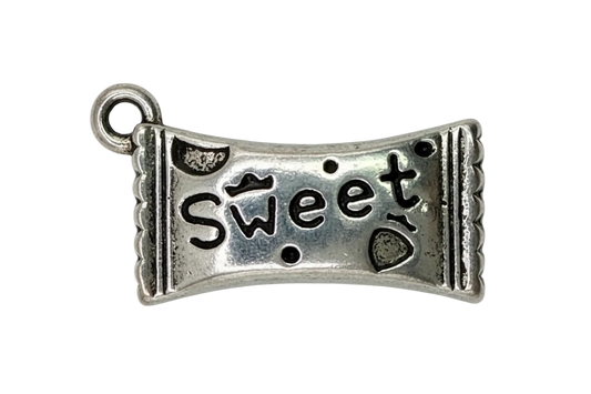 Antiqued silver banner piece with cutout “jeans” lettering and small cowboy hat detail