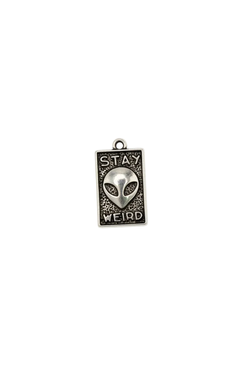 Antiqued silver alien plaque with “STAY WEIRD” text