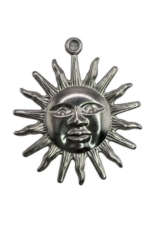 Silver sun face with sculpted rays and a small clear gem accent