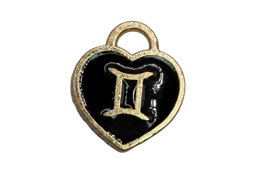 Black enamel heart with gold Gemini symbol and small white stone accent