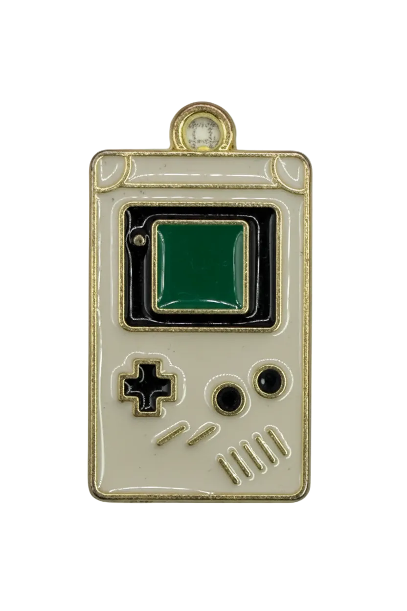 Cream and black enamel handheld game console with green screen and gold outline