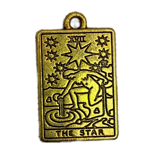 Rectangular gold tarot card charm with “THE STAR” text and celestial starburst engraving