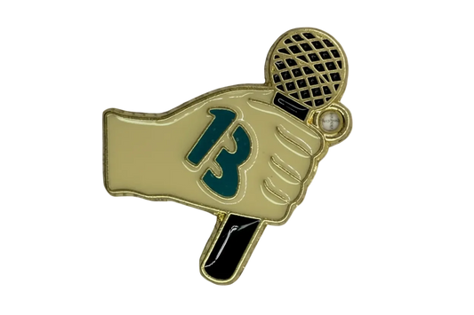 Gold-outlined enamel gloved hand holding a black tennis racket with teal detail and a small white gem