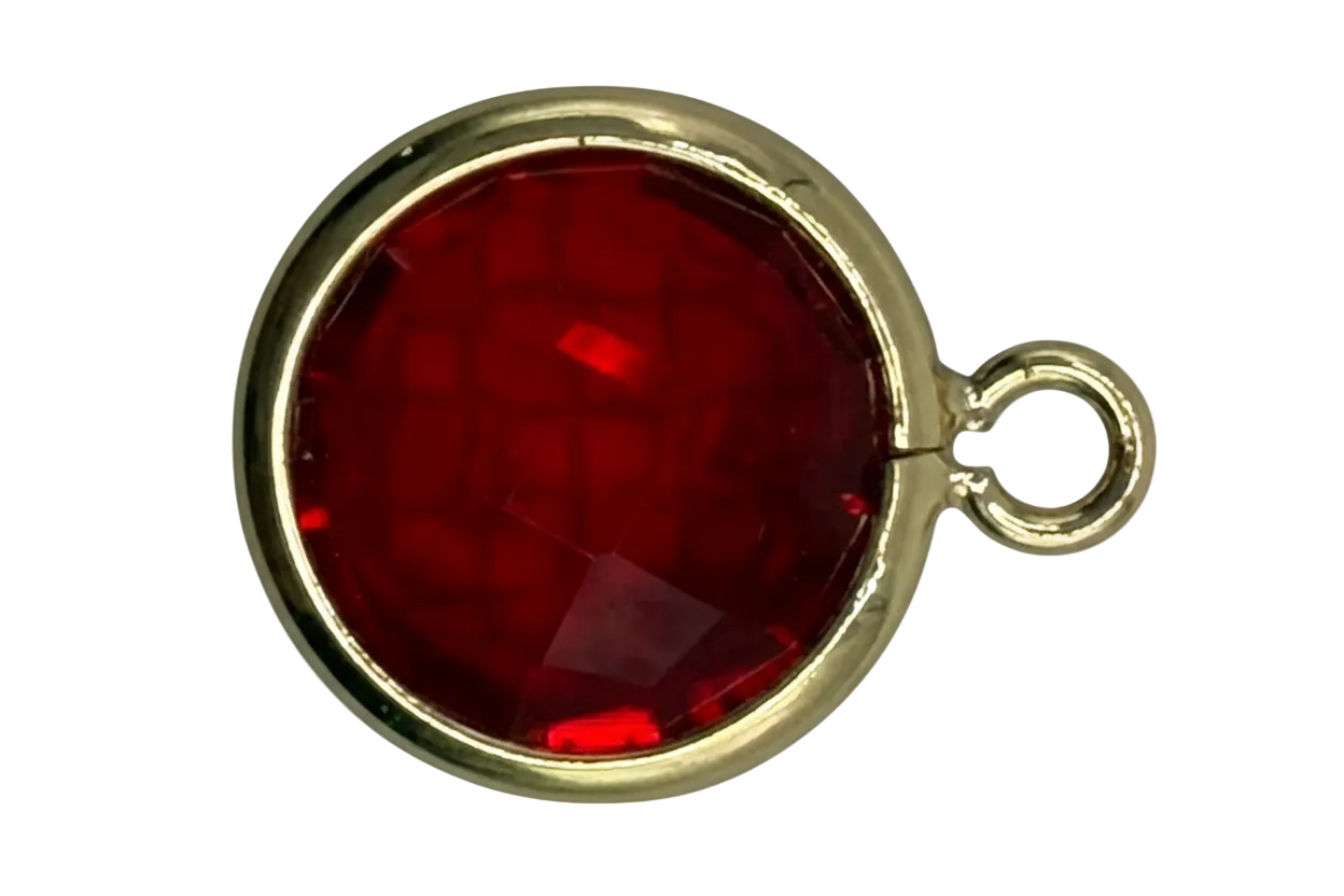 Faceted deep red round gem framed in gold with a small side ring detail