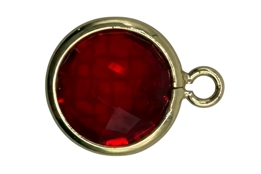 Faceted deep red round gem framed in gold with a small side ring detail