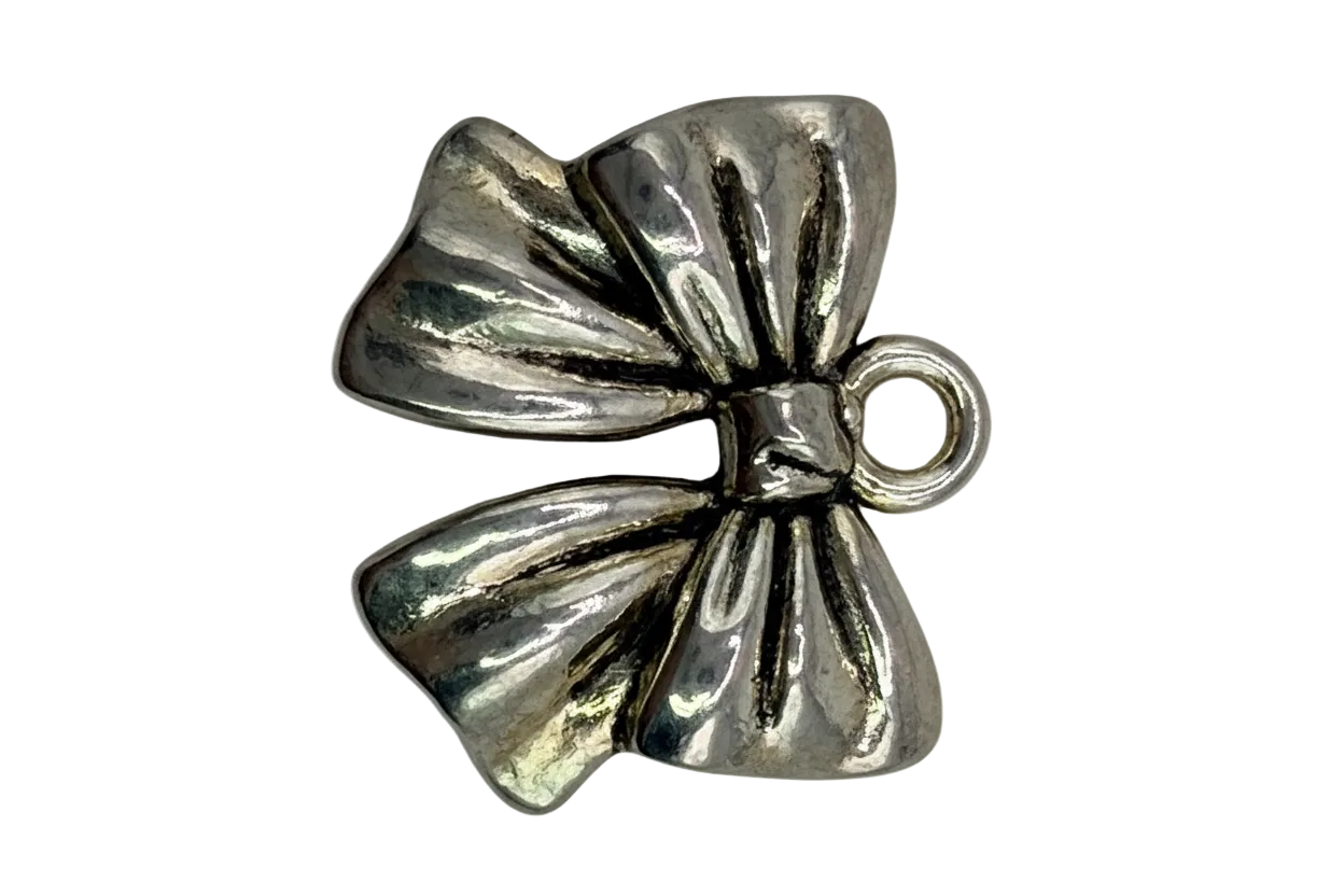 Polished silver ribbon bow charm with sculpted folds and subtle antiqued details