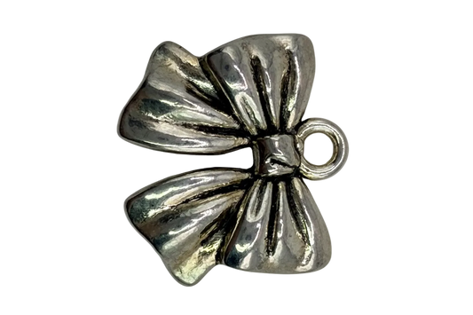 Polished silver ribbon bow charm with sculpted folds and subtle antiqued details