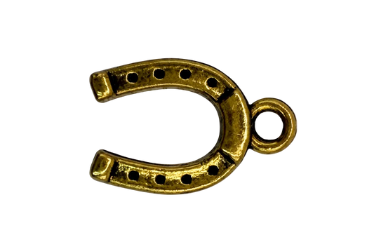 Gold horseshoe charm with dotted cutouts and antiqued detailing
