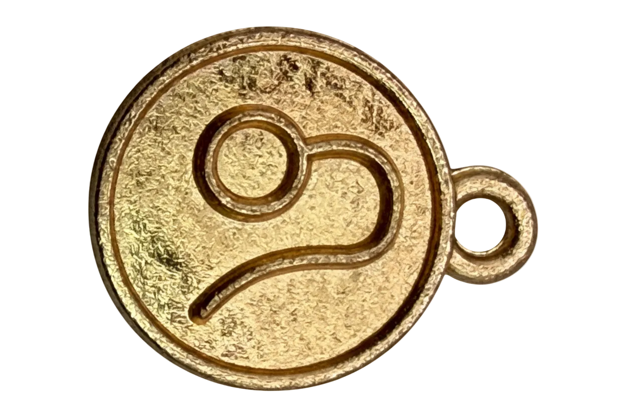 Round gold medallion charm with embossed music note motif and textured satin finish