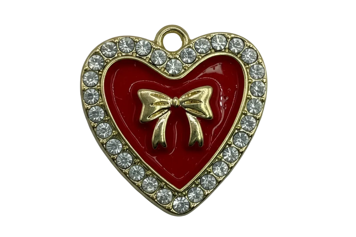 Glossy red heart with gold bow and clear crystal border in a gold finish