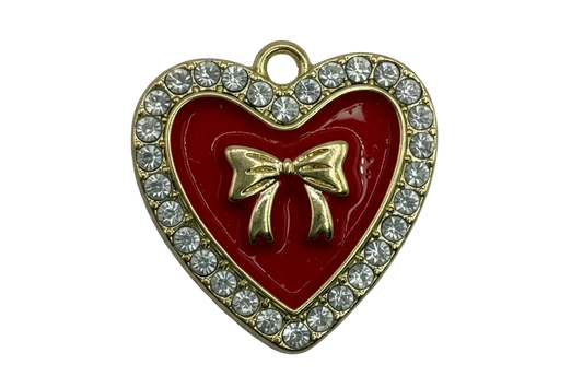 Glossy red heart with gold bow and clear crystal border in a gold finish