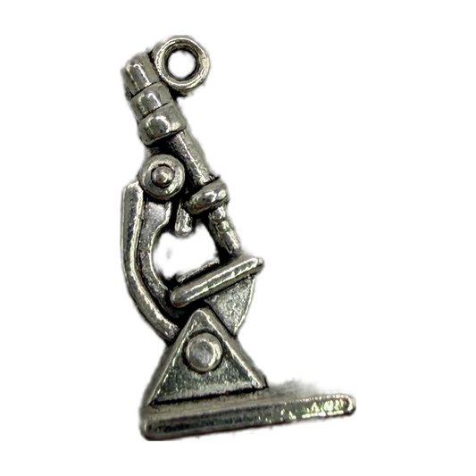Vintage-style silver microscope with oxidized finish and detailed sculpted metal silhouette