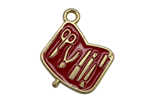 Glossy red enamel manicure tools tag with gold detailing
