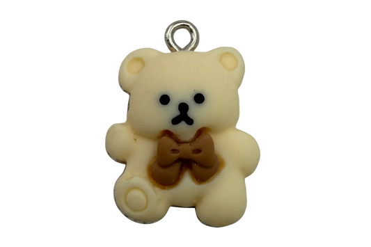 Ivory teddy bear charm with brown bow and black facial details, silver top