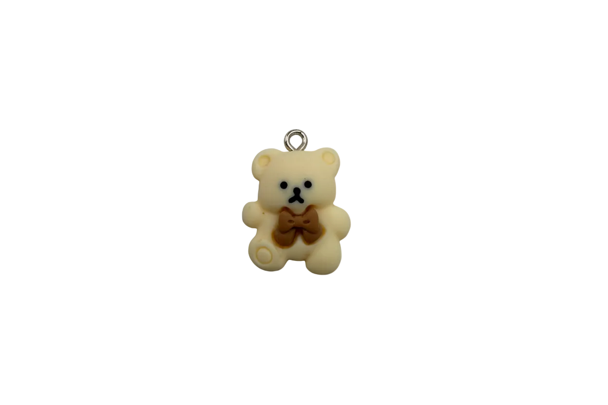 Ivory teddy bear with brown bow, silver top